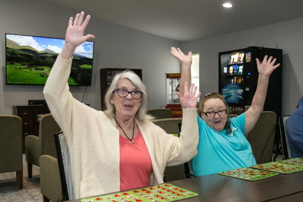 two seniors enjoying playing board games